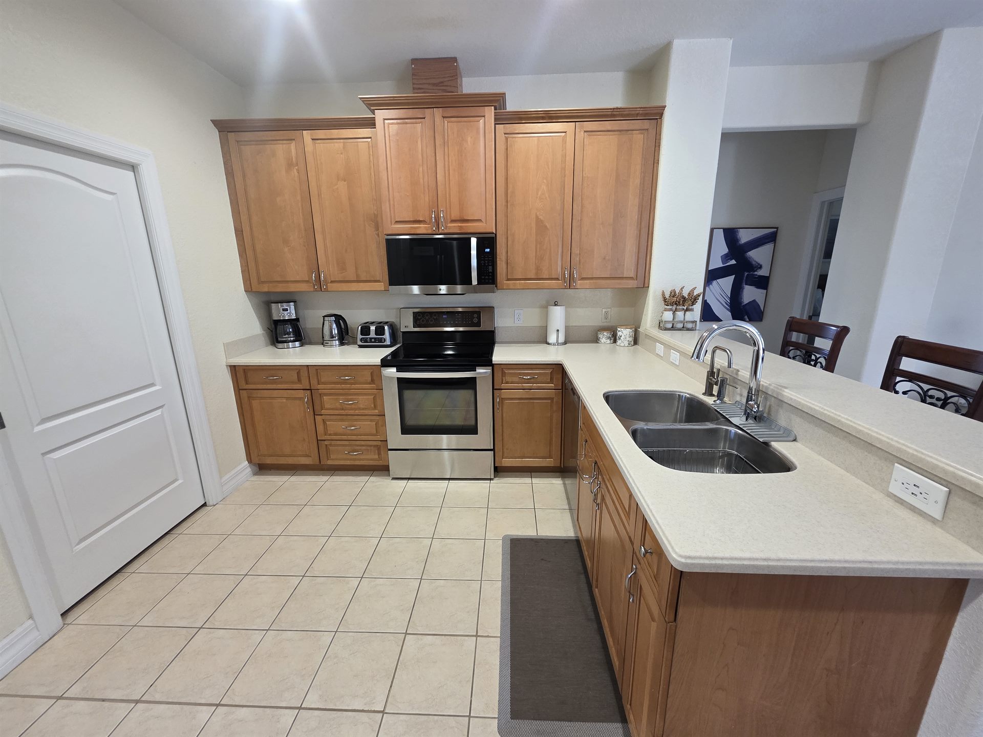 Kitchen stove, cabinets, and sink area